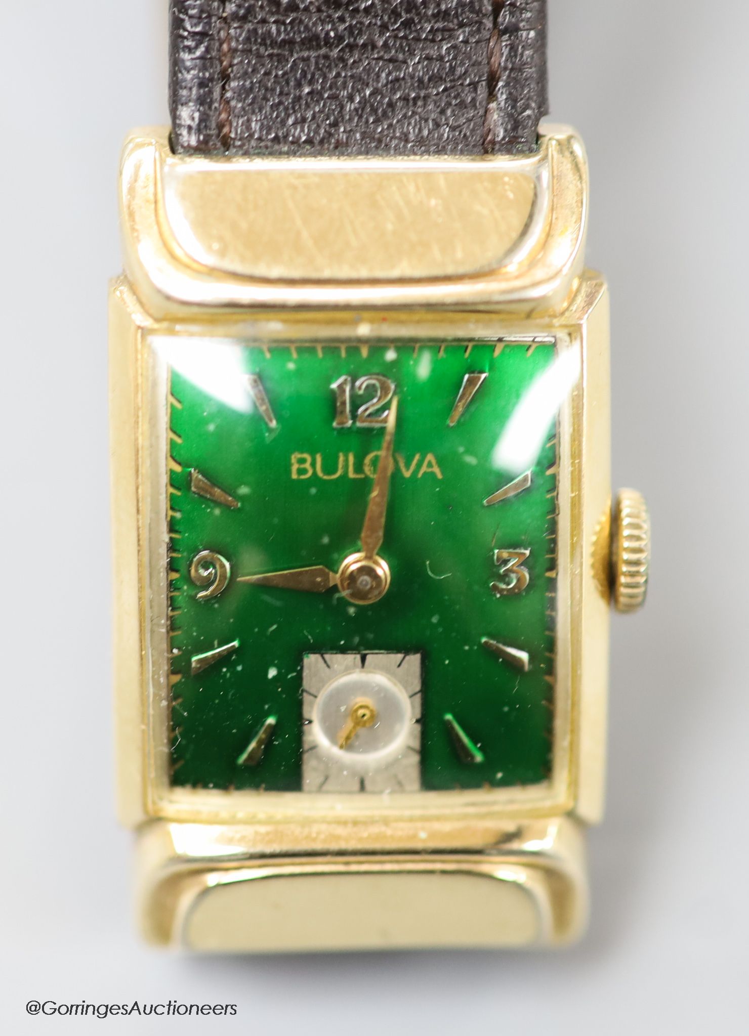 A gentleman's 1930's 10k gold filled Bulova manual wind wrist watch, with green enamel rectangular dial and subsidiary seconds, on later leather strap.